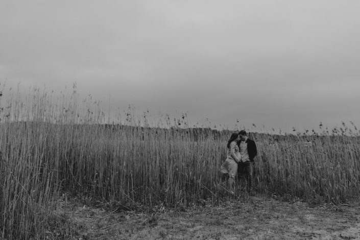 Mum and dad are standing and cuddling to each other. Maternity photo session in Hampshire. Hampshire photographer. Ewa Jones Photography