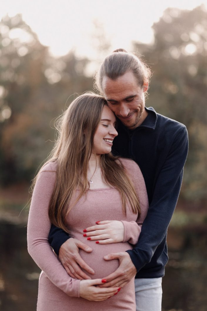 Expecting parents are cuddling and standing with each other. maternity poses. winter maternity session. Ewa Jones Photography