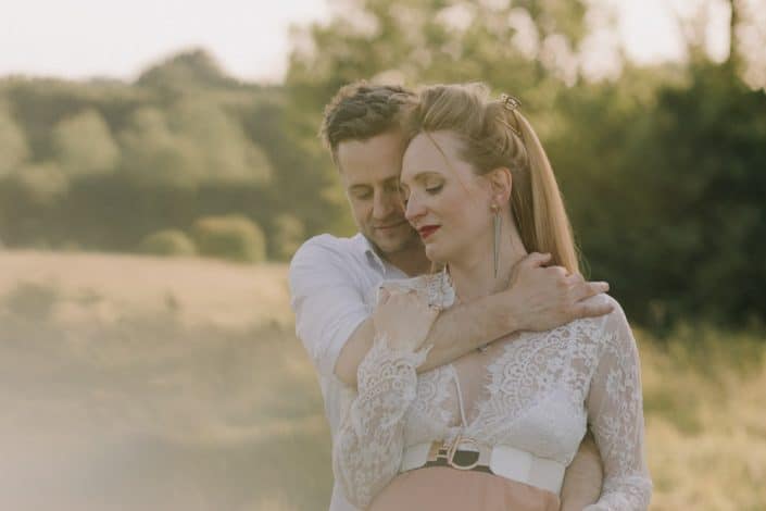 Mum to be and dad to be are hugging. Lovely maternity photo session in the summer. Intimate maternity session. maternity photographer in Hampshire. Ewa Jones Photography