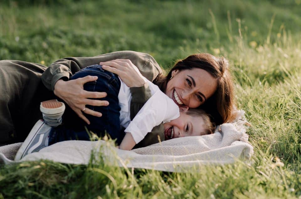 A Heartwarming Spring Photo Session with Mum and Son. mum is cuddling her boy and smiling. Fun in the fields. Mum and son photo session in Hampshire. Hampshire photographer. Ewa Jones Photography