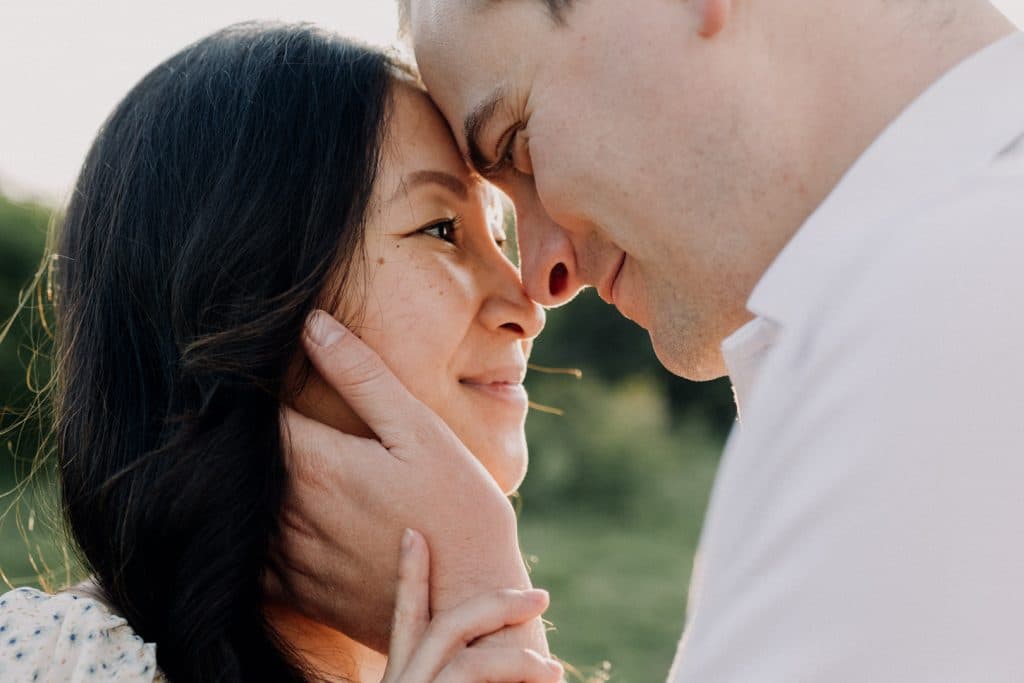 Close up of female and male together. They are touching their foreheads and looking at each other. Intimate maternity photo session. Maternity photographer in Hampshire. Basingstoke maternity photographer. Ewa Jones Photography