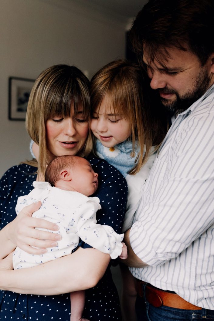 family of four is cuddling. lovely natural newborn photo session at home. Lifestyle session. Ewa Jones Photography